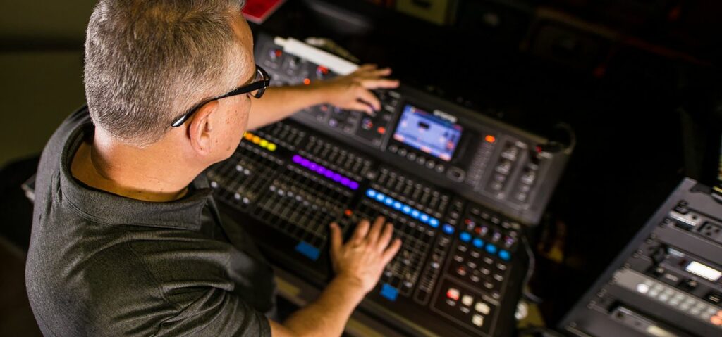 pexels photo 3042642 3042642 Sound engineer working on a professional audio console in a studio setting, focusing on the mix.
